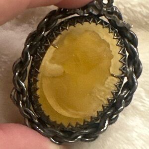 Elegant Amber Cameo Brooch with Silver Braided Frame